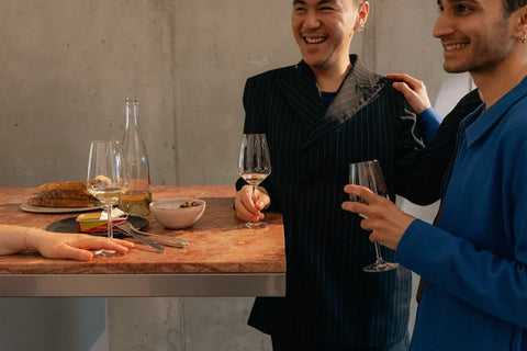 Guests enjoy wine and conversation around a table at Community Wine & Spirits.