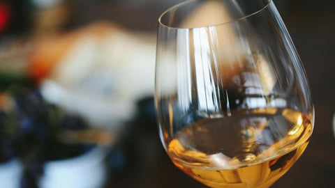 Glass of white wine with a clear golden color 